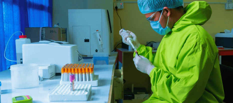 Picture of scientist wearing a green coat in lab